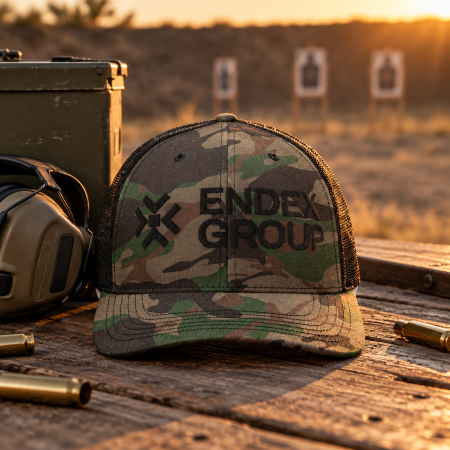 ENDEX GROUP camouflage trucker hat on a shooting bench at golden hour