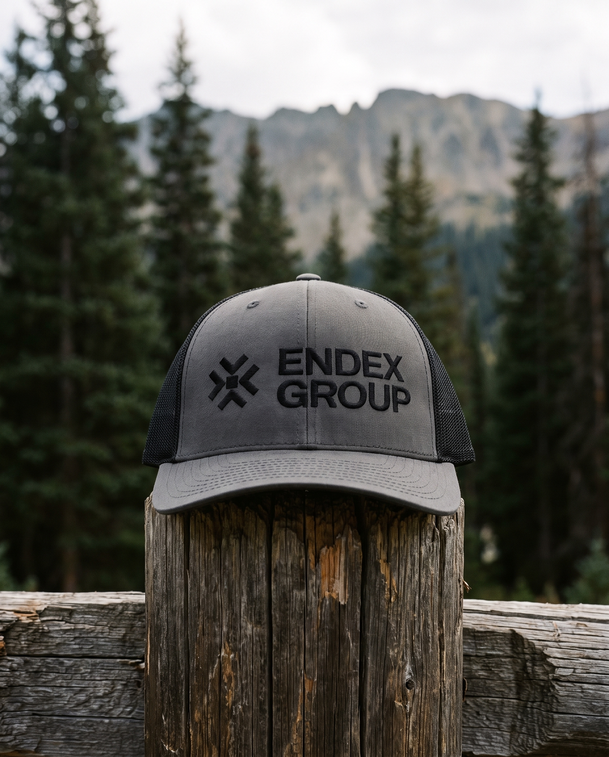 ENDEX Classic Trucker Cap on an alpine fence post